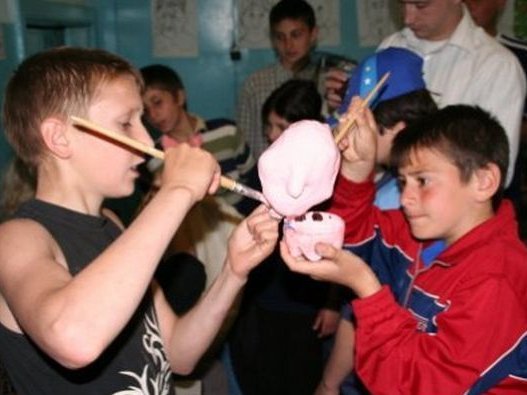 Students painting sculptures.